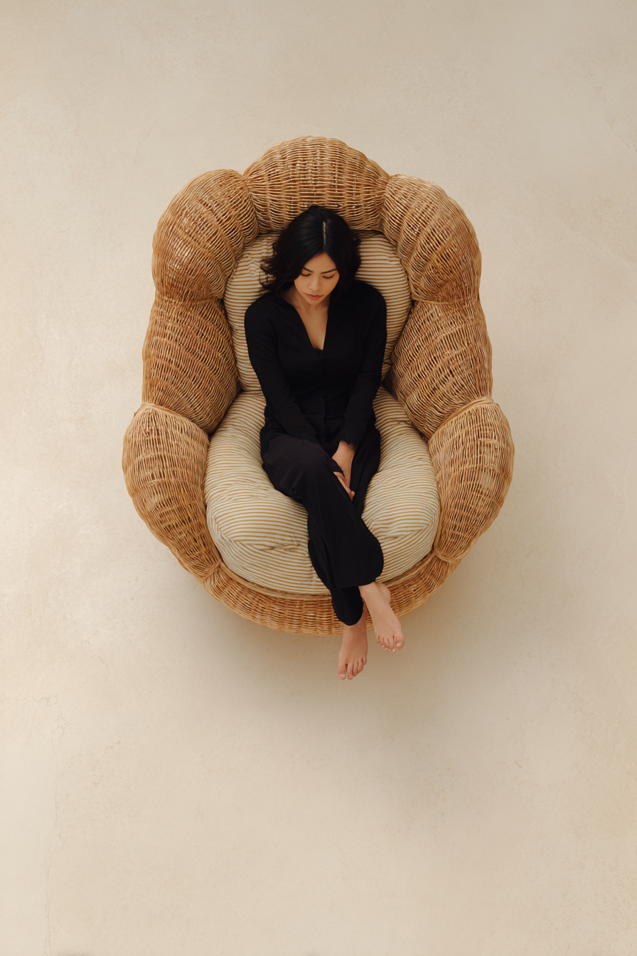 u4133367271_Top_view_of_a_rattan_lounge_chair_placed_on_a_sof_ab58fc2d-62a8-408a-9ef1-0a3475adcebd_0.png